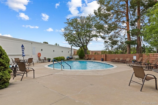 pool featuring a patio and fence