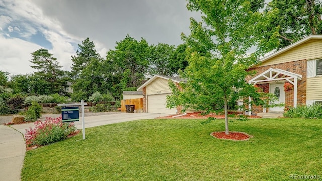 8217 Club Crest Dr, Arvada, CO 80005 - view of front of house with a front lawn, concrete driveway, brick siding, and an attached garage