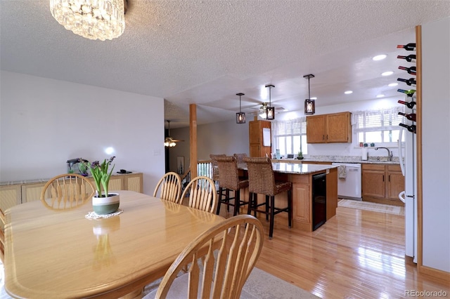 8217 Club Crest Dr, Arvada, CO 80005 - dining space with ceiling fan, light wood-style flooring, a textured ceiling, and recessed lighting