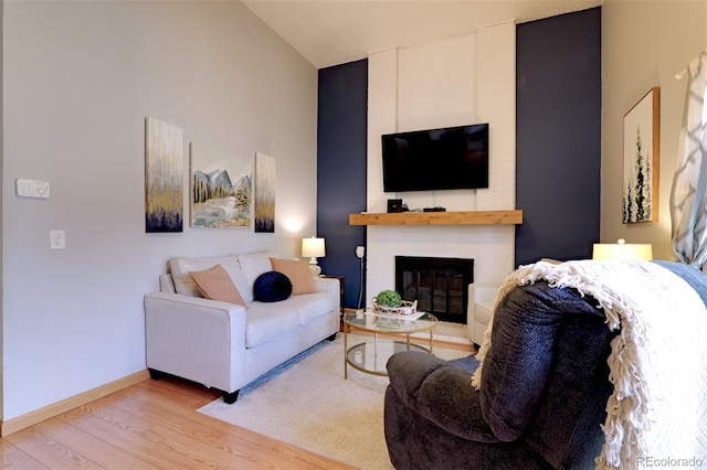 8217 Club Crest Dr, Arvada, CO 80005 - living room featuring wood finished floors, a fireplace, and lofted ceiling