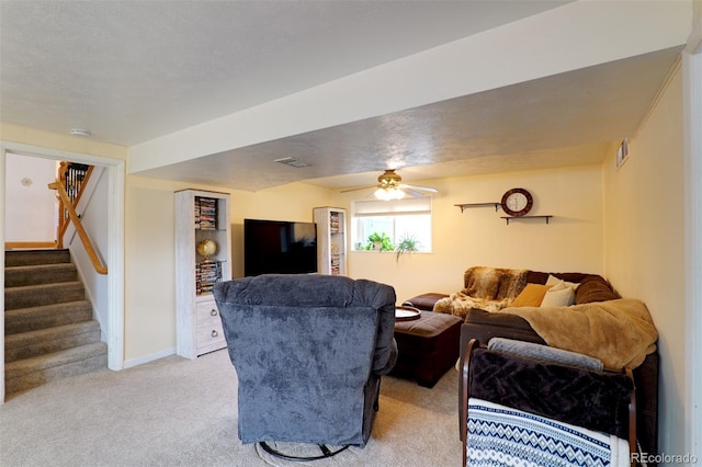 8217 Club Crest Dr, Arvada, CO 80005 - living room with light carpet, stairway, and ceiling fan
