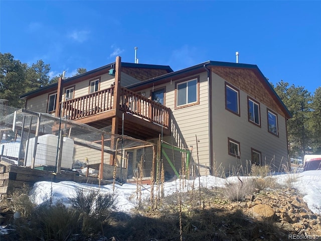 snow covered property featuring a deck