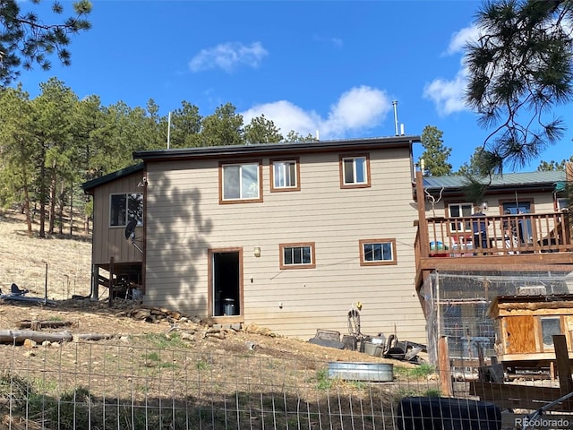 back of property with a wooden deck