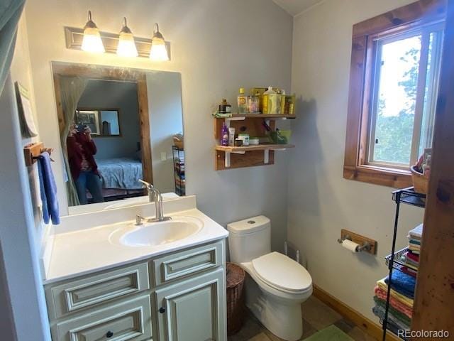 bathroom featuring vanity and toilet