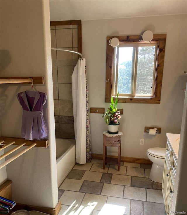 full bathroom featuring vanity, shower / bath combo with shower curtain, and toilet