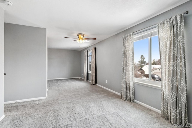 unfurnished room with baseboards, carpet floors, and ceiling fan