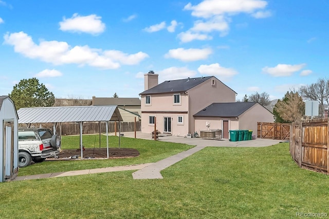 1206 Baldwin Park Cir, Castle Rock, CO 80104 - back of house with stucco siding, a chimney, a patio, and a detached carport
