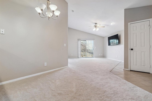 empty room with ceiling fan with notable chandelier, light carpet, and vaulted ceiling