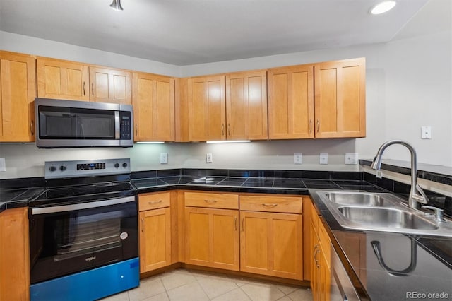 kitchen featuring light tile patterned floors, sink, and appliances with stainless steel finishes