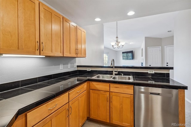 kitchen with stainless steel dishwasher, sink, pendant lighting, an inviting chandelier, and lofted ceiling