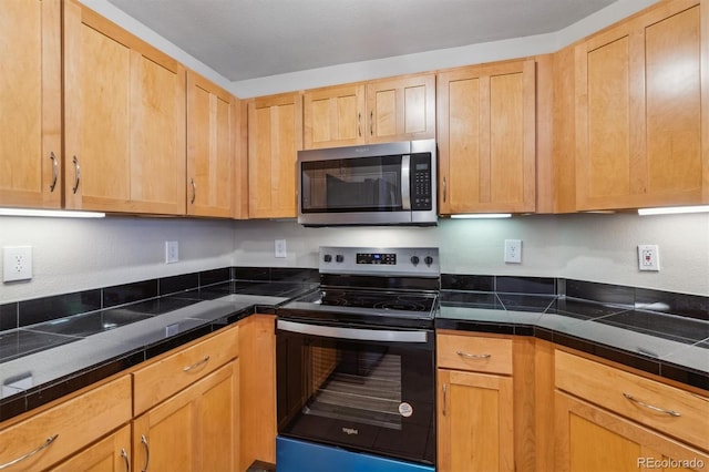 kitchen featuring light brown cabinetry and appliances with stainless steel finishes