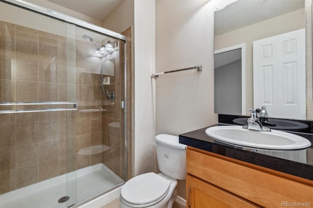 bathroom with vanity, toilet, and walk in shower