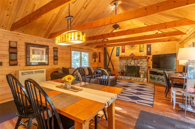 4745 Forest Ln, Howard, CO 81233 - dining space with wood walls, wood finished floors, a fireplace, and wood ceiling