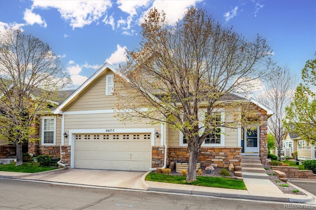 view of front of house featuring an attached garage, stone siding, and concrete driveway