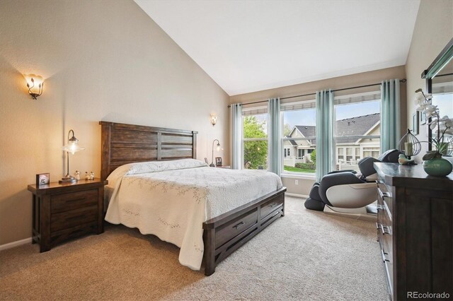 carpeted bedroom featuring baseboards and high vaulted ceiling