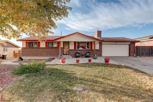 single story home featuring a garage, a front lawn, and covered porch