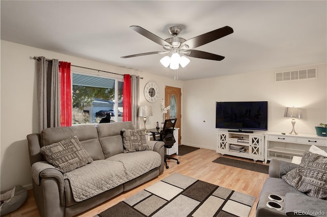 living room with ceiling fan and light hardwood / wood-style flooring