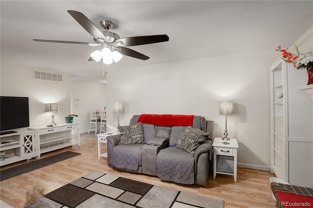 living room featuring ceiling fan and light wood-type flooring