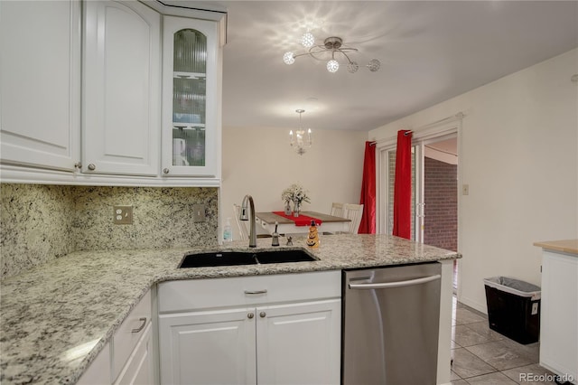 kitchen featuring tasteful backsplash, white cabinetry, a notable chandelier, sink, and stainless steel dishwasher