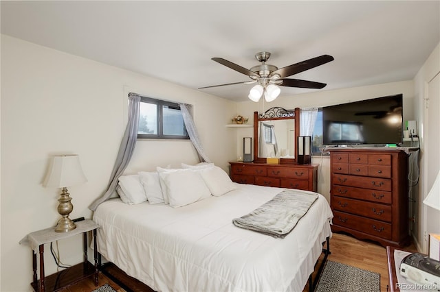 bedroom with wood-type flooring and ceiling fan