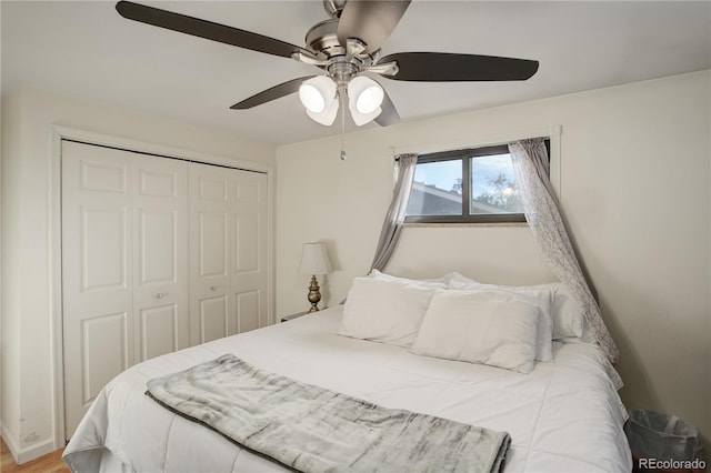 bedroom with a closet, hardwood / wood-style floors, and ceiling fan