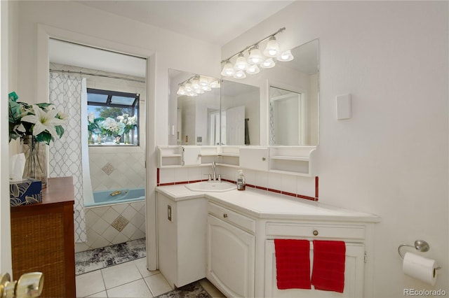 bathroom featuring tile patterned flooring, a bathtub, and vanity