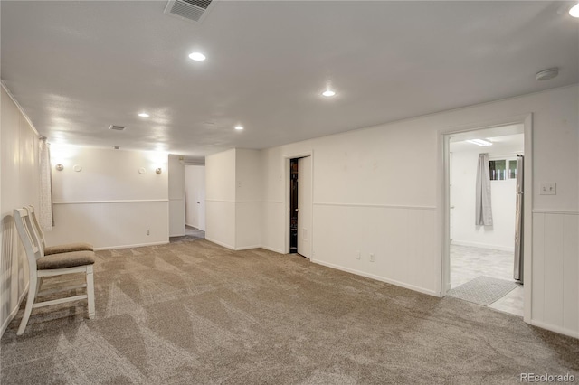 basement featuring light carpet