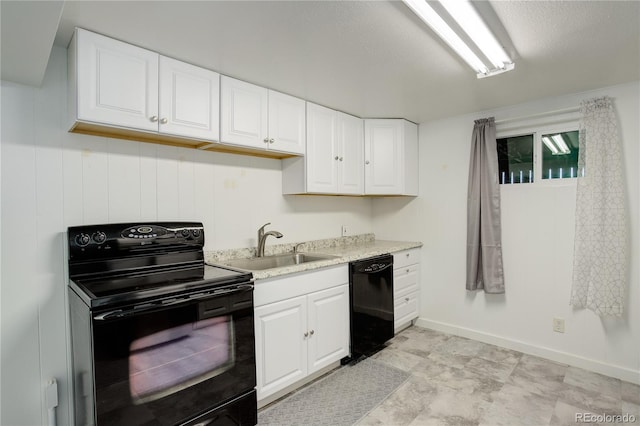 kitchen featuring white cabinetry, sink, black appliances, and a textured ceiling