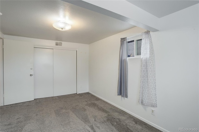 unfurnished bedroom featuring a closet and carpet