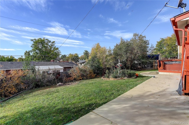 view of yard with a hot tub and a patio