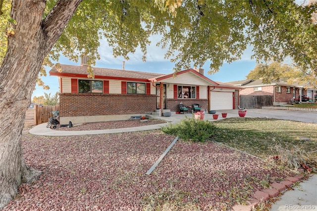 ranch-style house with a garage and a front lawn