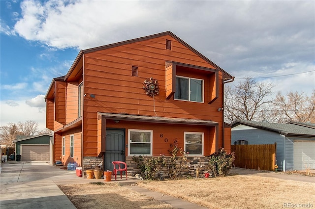 view of front of house featuring a garage and an outdoor structure