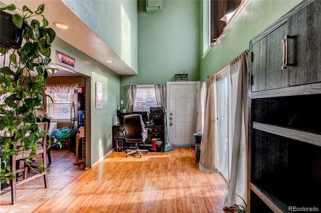 office featuring wood-type flooring and a high ceiling