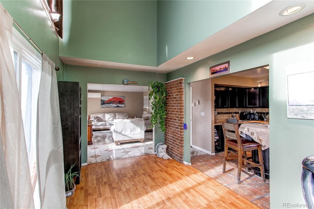 interior space featuring wood-type flooring and a towering ceiling