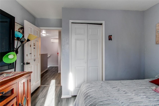 bedroom featuring a closet and dark wood-type flooring