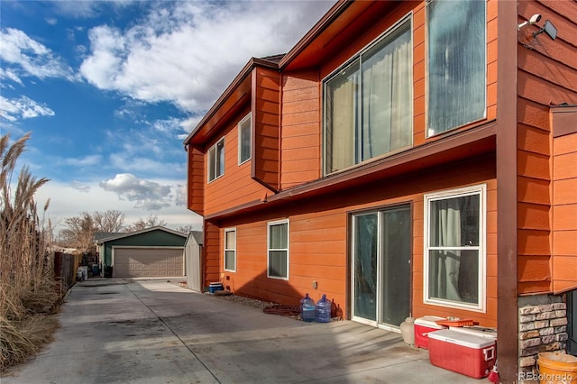 view of side of home featuring an outdoor structure and a garage