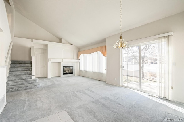 unfurnished living room with light colored carpet and high vaulted ceiling