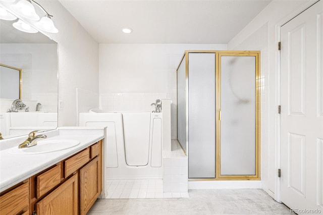 bathroom featuring tile patterned floors, vanity, and separate shower and tub