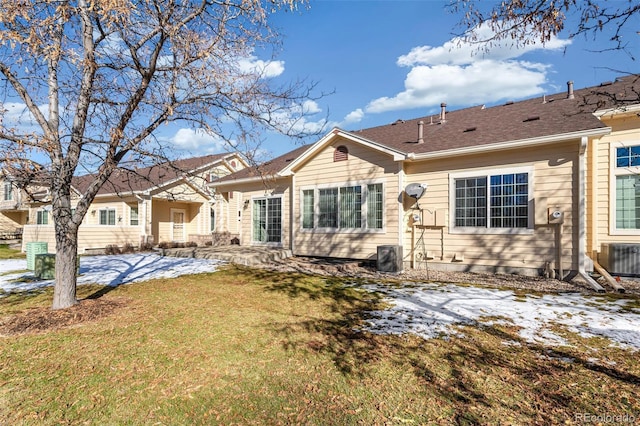 snow covered property with cooling unit, a yard, and a patio area