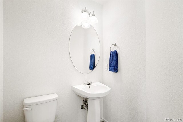 bathroom featuring sink and toilet