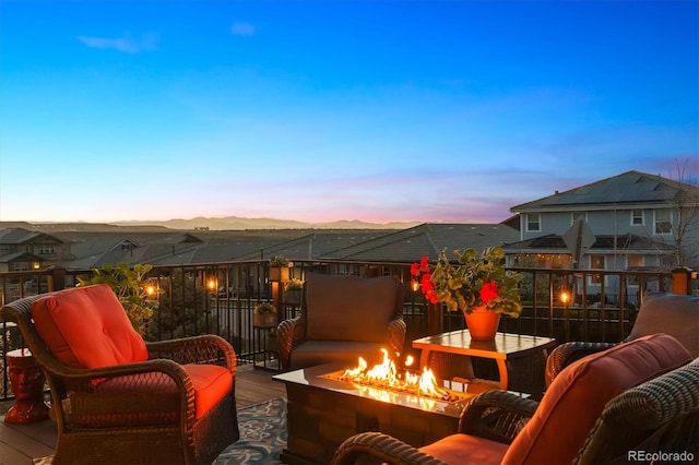 balcony at dusk with an outdoor fire pit