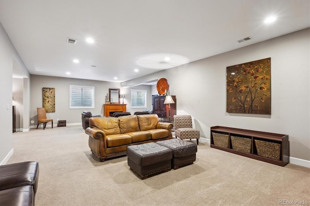 living area featuring recessed lighting, visible vents, and carpet