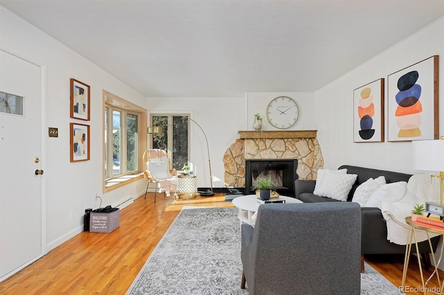 living room with a fireplace and light wood-type flooring