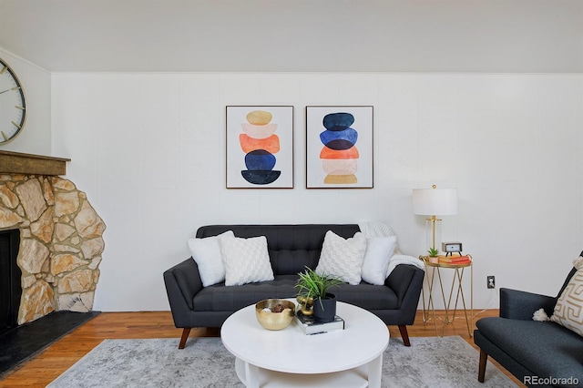 living room with hardwood / wood-style floors and a fireplace