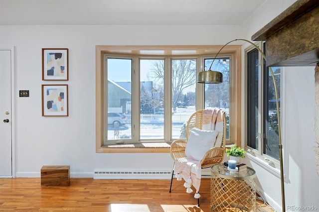 sitting room featuring a wealth of natural light and light hardwood / wood-style floors