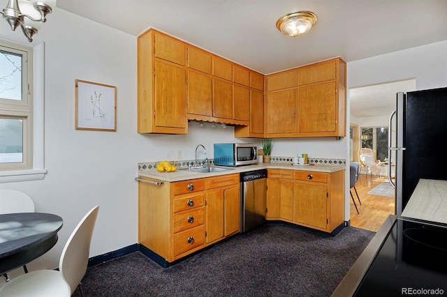 kitchen with sink and appliances with stainless steel finishes