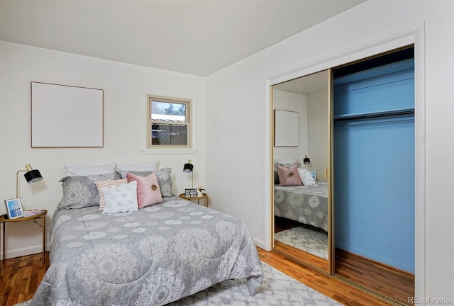 bedroom featuring hardwood / wood-style floors and a closet