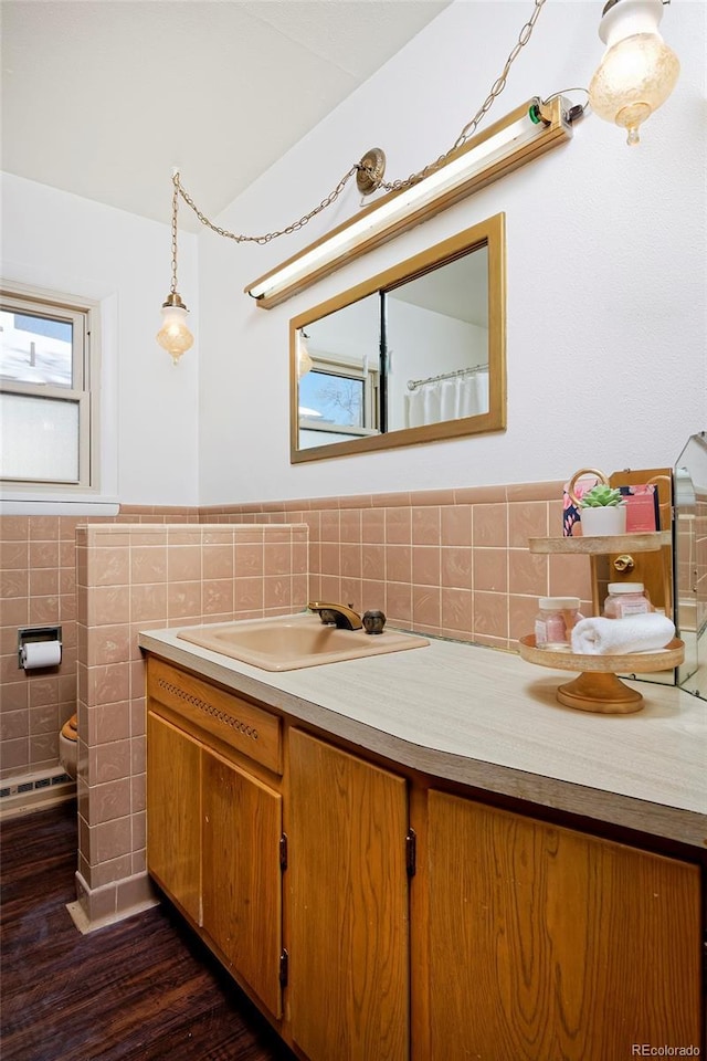 bathroom with hardwood / wood-style flooring, vanity, tile walls, and toilet