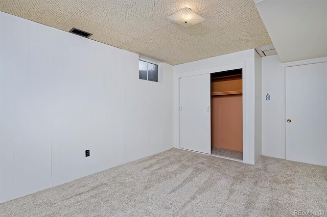 unfurnished bedroom featuring carpet floors and a closet