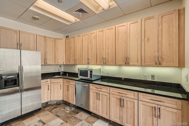 1499 Blake St Unit 1A & 1B, Denver, CO 80202 - kitchen with appliances with stainless steel finishes, light brown cabinetry, a sink, and dark countertops